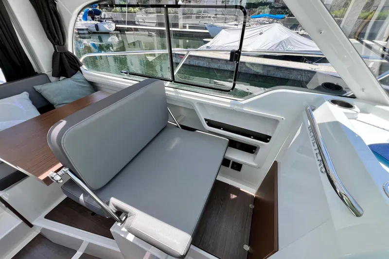 Slide: The Image of Interior of 2023 Beneteau Antares 8 boat with seating and window view. - 49