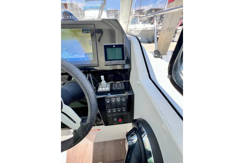Slide: The Image of 2023 Beneteau Antares 8 cockpit with navigation controls and steering wheel. - 56