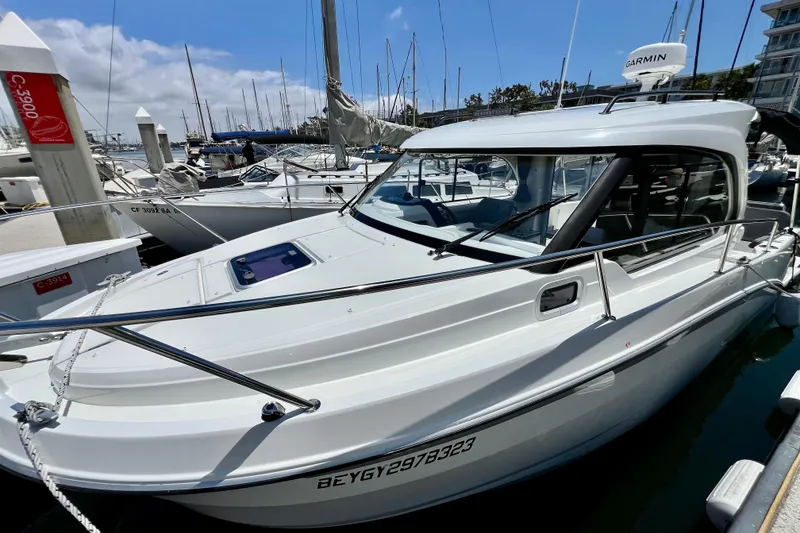 Slide: The Image of 2023 Beneteau Antares 8 docked at marina, surrounded by other boats. - 27