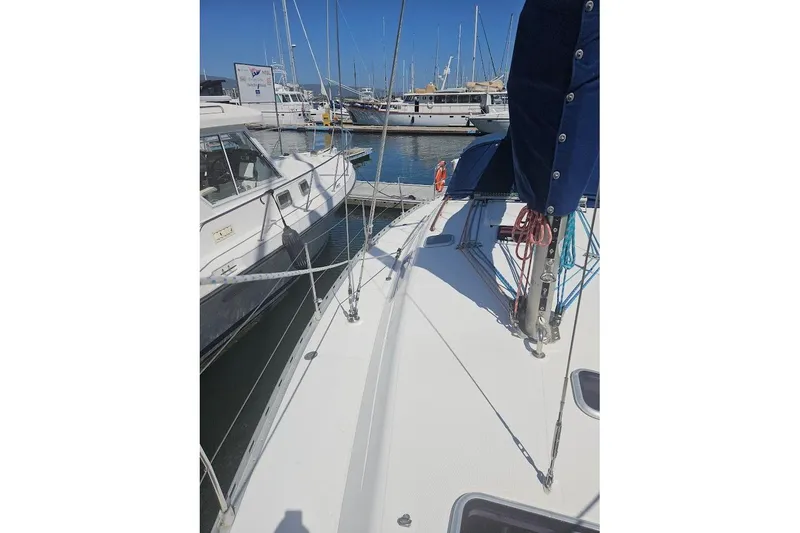 Slide: The Image of Sailboat Dufour 36 Classic, 2001 model, docked in a marina with other boats. - 7
