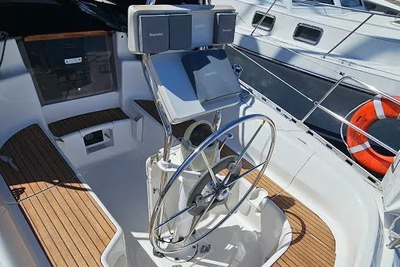 Slide: The Image of Steering wheel of 2001 Dufour 36 Classic yacht with wooden deck and navigation equipment. - 3