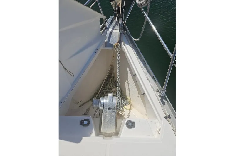 Slide: The Image of Anchor chain and windlass on 2001 Dufour 36 Classic sailboat deck. - 6
