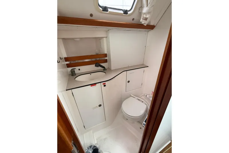 Slide: The Image of Bathroom interior of 2001 Dufour 36 Classic yacht, featuring sink and toilet. - 8