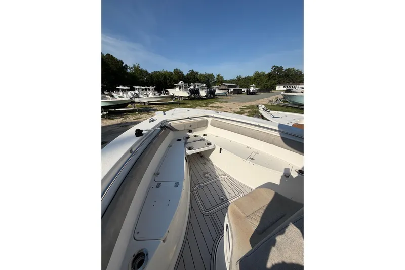 Slide: The Image of 2020 Sea Pro 259 Center Console boat interior with seating and deck view. - 4