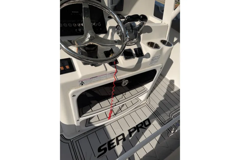 Slide: The Image of 2020 Sea Pro 259 Center Console boat helm with steering wheel and controls. - 8