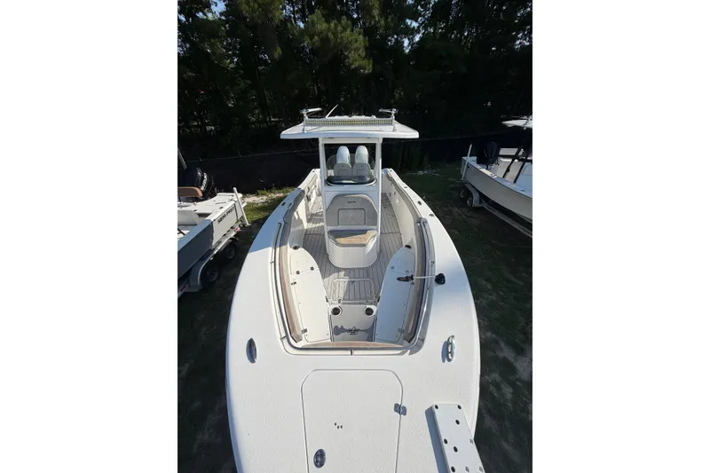 Slide: The Image of 2020 Sea Pro 259 Center Console boat, white exterior, docked outdoors. - 3
