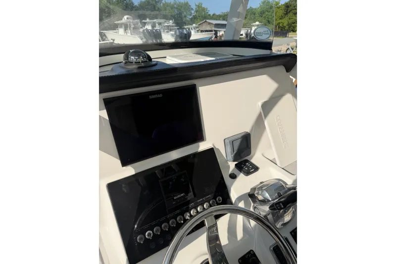 Slide: The Image of 2020 Sea Pro 259 Center Console dashboard with navigation equipment and controls. - 9