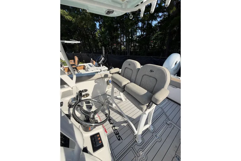 Slide: The Image of 2020 Sea Pro 259 Center Console boat interior with dual seats and steering wheel. - 6