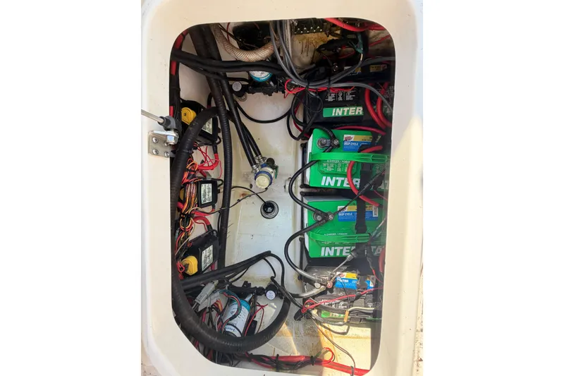 Slide: The Image of Electrical compartment of a 2020 Sea Pro 259 Center Console boat with batteries and wiring. - 14