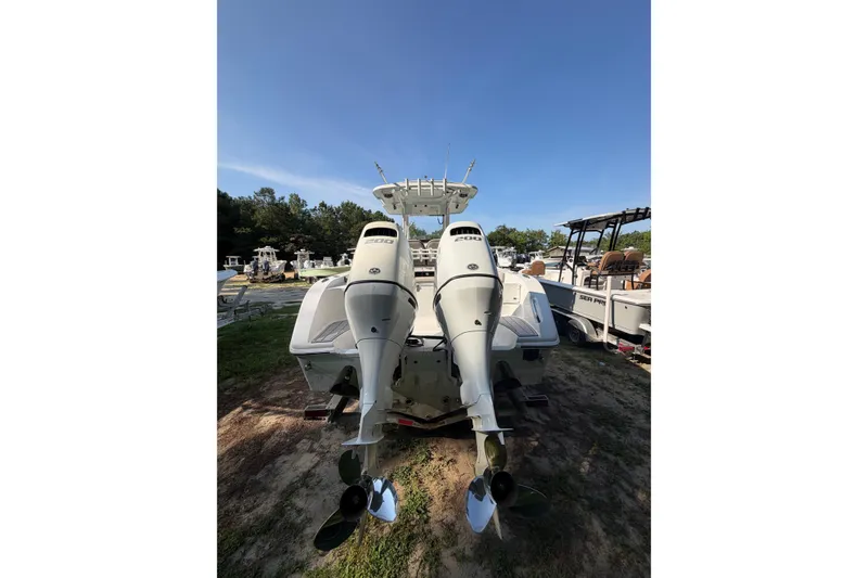 Slide: The Image of 2020 Sea Pro 259 Center Console boat with dual outboard engines, parked outdoors. - 10