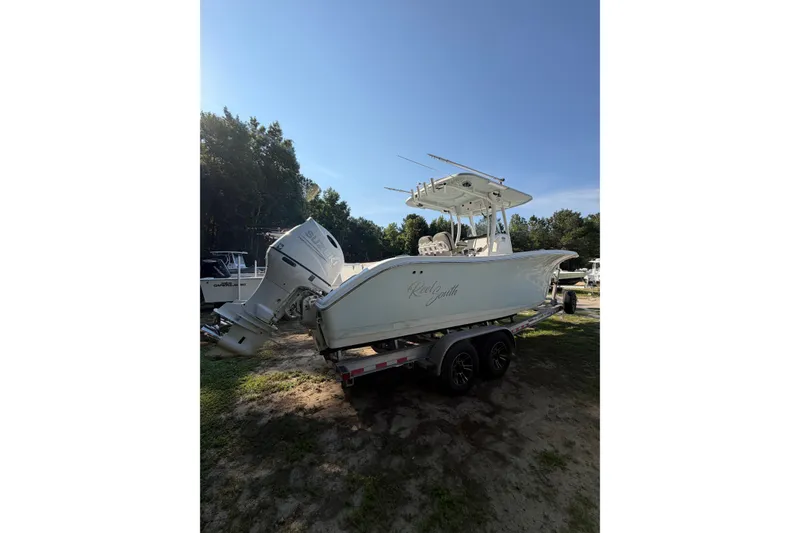 Slide: The Image of 2020 Sea Pro 259 Center Console boat on trailer, parked outdoors. - 2