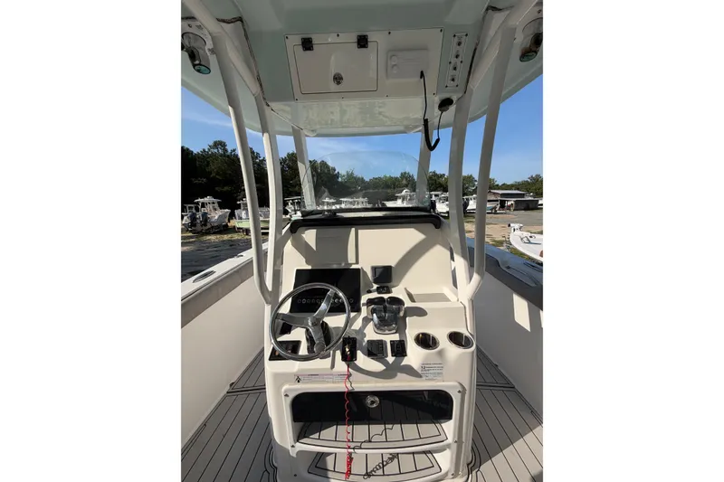Slide: The Image of 2020 Sea Pro 259 Center Console boat interior with steering wheel and control panel. - 7