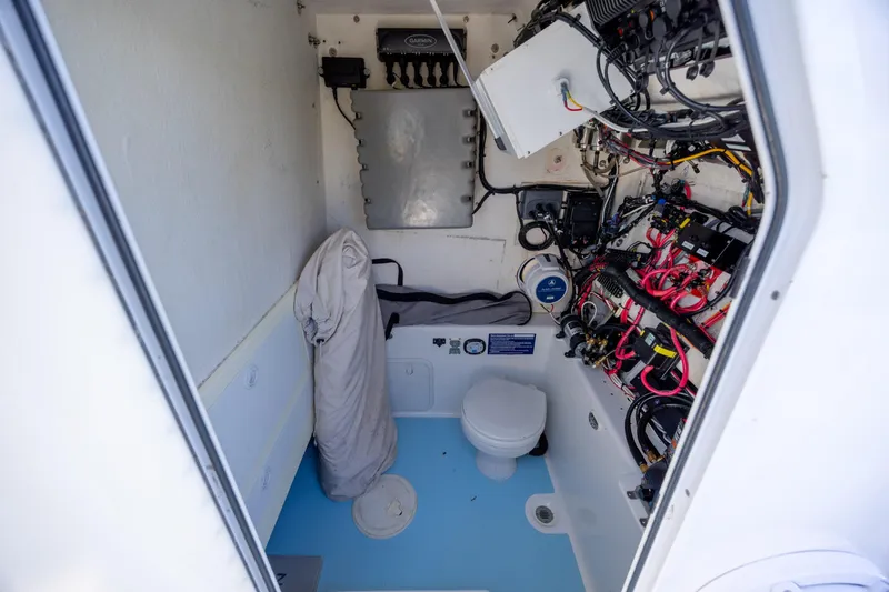 Slide: The Image of Interior of 2011 Albury Brothers 27 boat showing wiring and toilet setup. - 12