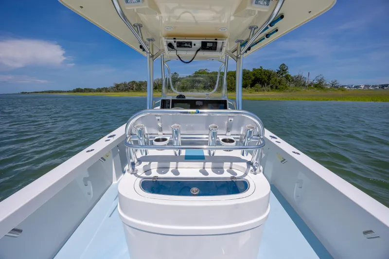 Slide: The Image of 2011 Albury Brothers 27 boat on calm water, featuring a sleek center console design. - 23