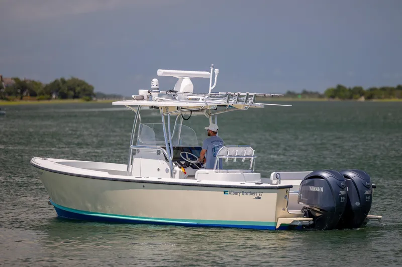 Slide: The Image of 2011 Albury Brothers 27 boat with dual Yamaha engines on a calm waterway. - 5