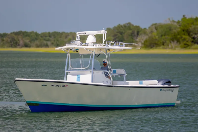 Slide: The Image of 2011 Albury Brothers 27 boat on calm water with lush green shoreline. - 3