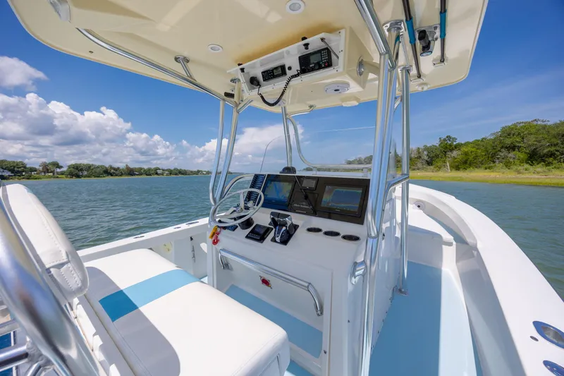 Slide: The Image of Albury Brothers 27 boat interior, 2011 model, featuring helm and navigation equipment on a sunny day. - 14