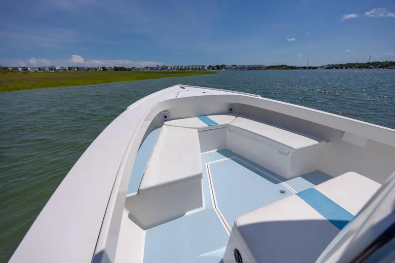 Slide: The Image of 2011 Albury Brothers 27 boat interior with seating, on a sunny day by the water. - 9