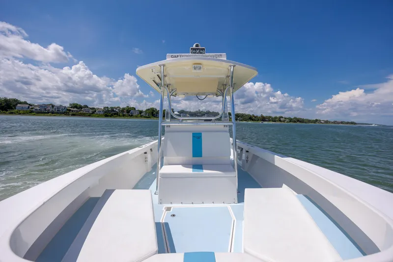 Slide: The Image of 2011 Albury Brothers 27 boat cruising on a sunny day with scenic coastal view. - 11