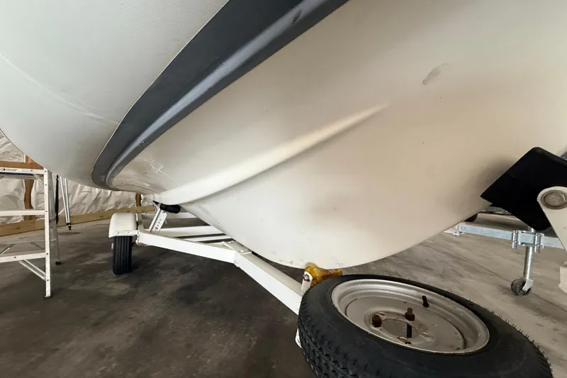 Slide: The Image of 2014 Walker Bay Generation 450 DLX boat on trailer, close-up view of hull and wheel. - 23