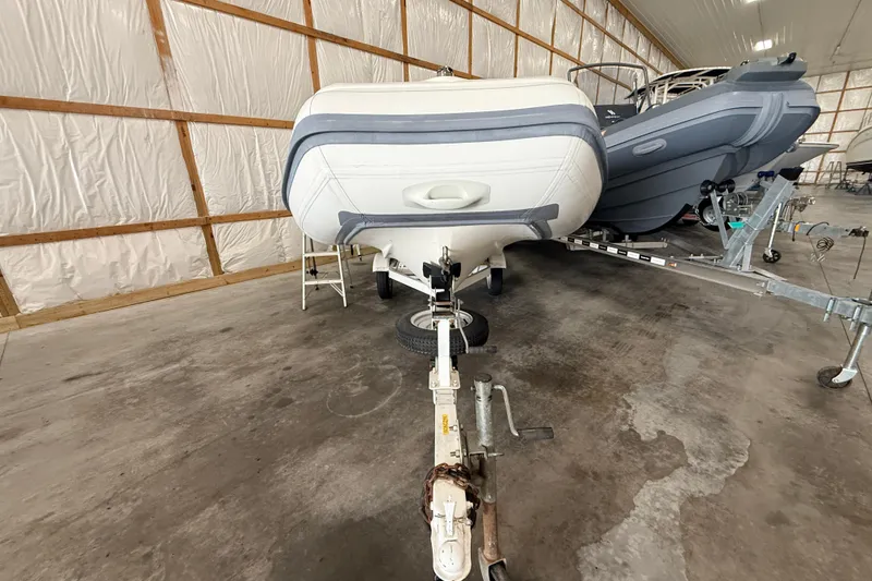 Slide: The Image of 2014 Walker Bay Generation 450 DLX boat on trailer in storage facility. - 6