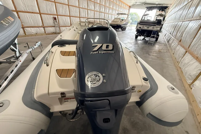 Slide: The Image of 2014 Walker Bay Generation 450 DLX boat with 70 HP engine in storage facility. - 10