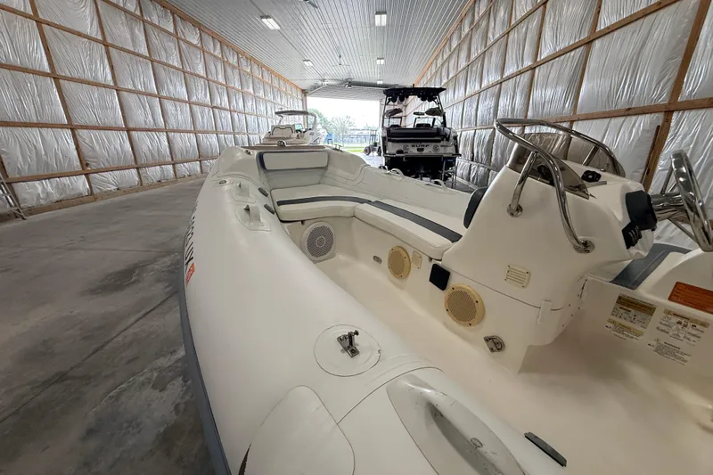 Slide: The Image of 2014 Walker Bay Generation 450 DLX boat in spacious indoor storage facility. - 4
