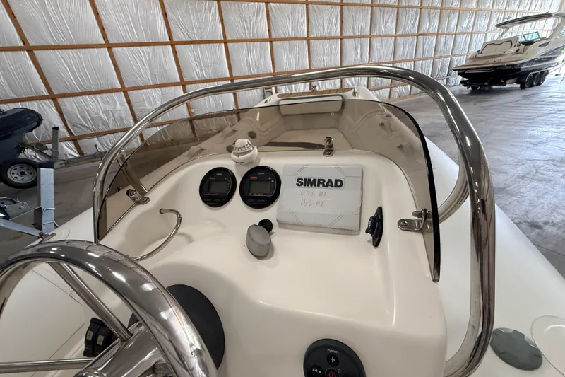 Slide: The Image of 2014 Walker Bay Generation 450 DLX boat dashboard with Simrad navigation system. - 15