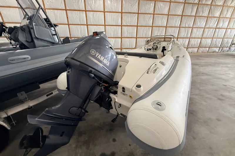 Slide: The Image of 2014 Walker Bay Generation 450 DLX boat with Yamaha outboard motor in storage. - 11
