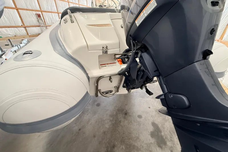 Slide: The Image of 2014 Walker Bay Generation 450 DLX boat with outboard motor in a storage facility. - 13