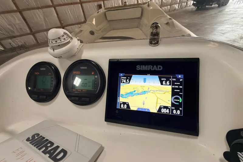 Slide: The Image of Dashboard of 2014 Walker Bay Generation 450 DLX with Simrad navigation system. - 21