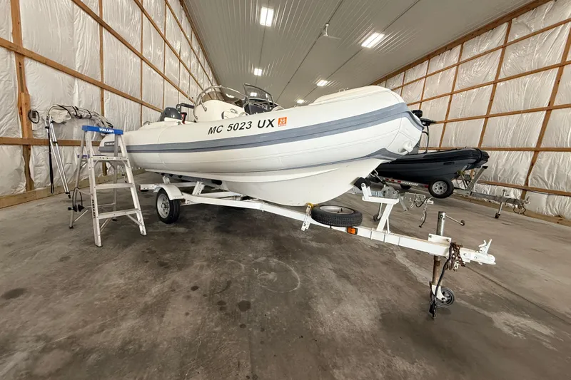 Slide: The Image of 2014 Walker Bay Generation 450 DLX boat on trailer in indoor storage facility. - 3