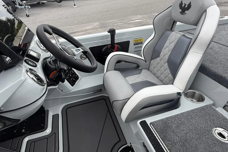 Slide: The Image of Interior of 2027 Phoenix 921 Elite X II boat with steering wheel and cushioned seat. - 13
