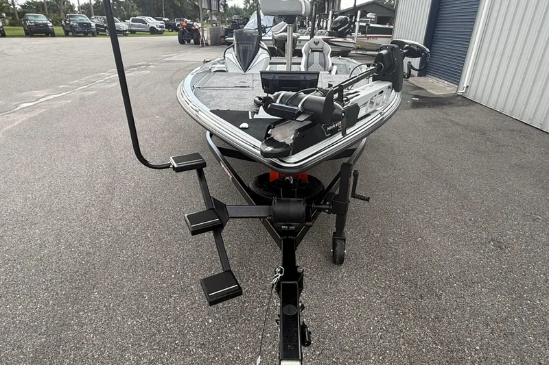 Slide: The Image of 2027 Phoenix 921 Elite X II boat on trailer, parked outdoors near a building. - 9