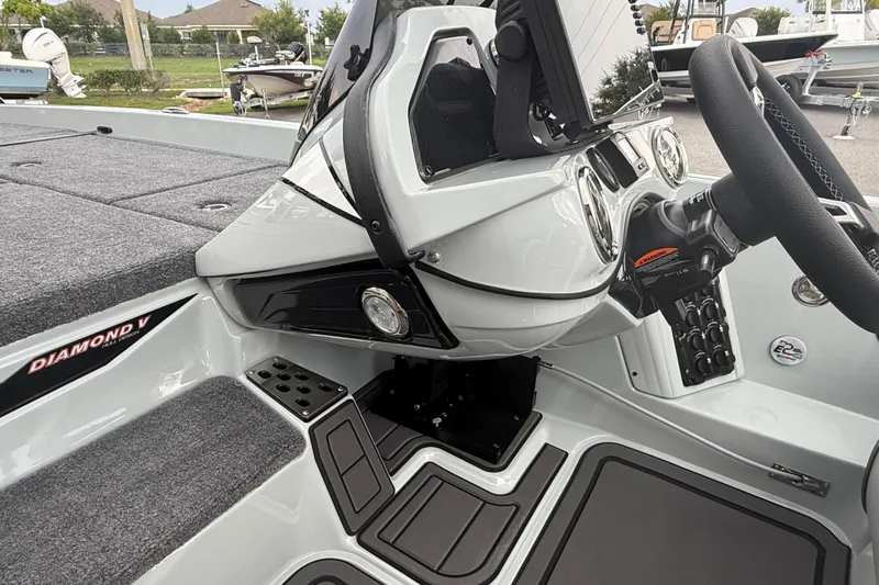 Slide: The Image of Interior of 2027 Phoenix 921 Elite X II boat, featuring steering wheel and dashboard controls. - 14