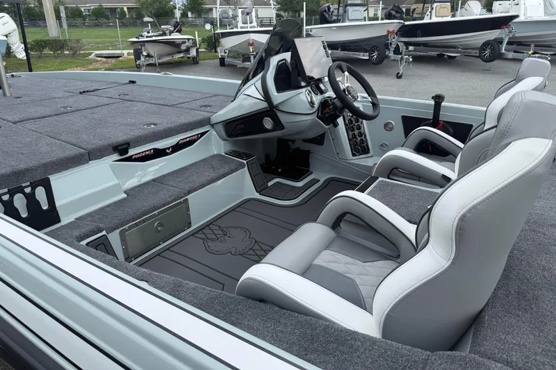 Slide: The Image of 2027 Phoenix 921 Elite X II boat interior with modern seating and control panel. - 21