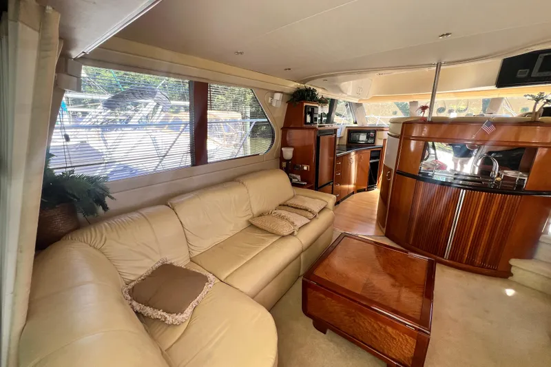 Slide: The Image of Luxurious interior of a 2003 Carver 450 Voyager Pilothouse yacht with leather seating and wood finishes. - 10
