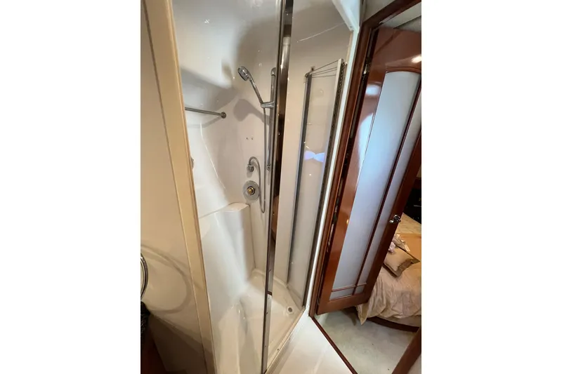 Slide: The Image of Shower area in 2003 Carver 450 Voyager Pilothouse yacht, featuring glass door and modern fixtures. - 32
