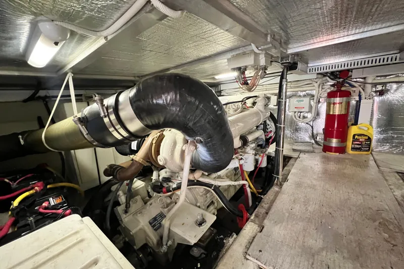 Slide: The Image of Engine room of 2003 Carver 450 Voyager Pilothouse with visible machinery and equipment. - 51