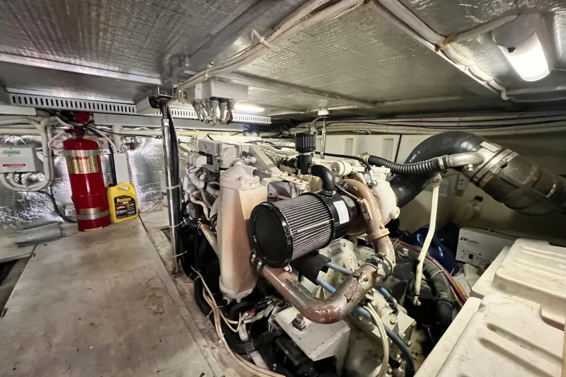 Slide: The Image of Engine room of 2003 Carver 450 Voyager Pilothouse with visible machinery and fire extinguisher. - 50