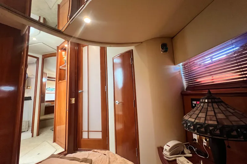 Slide: The Image of Interior of 2003 Carver 450 Voyager Pilothouse with wood paneling and cozy lighting. - 30