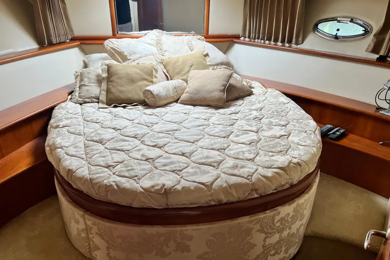 Slide: The Image of Luxurious bedroom interior of 2003 Carver 450 Voyager Pilothouse yacht with plush bedding. - 34