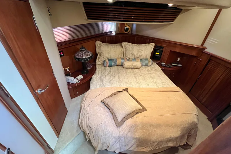 Slide: The Image of Luxurious bedroom interior of 2003 Carver 450 Voyager Pilothouse yacht with elegant wood finishes. - 27