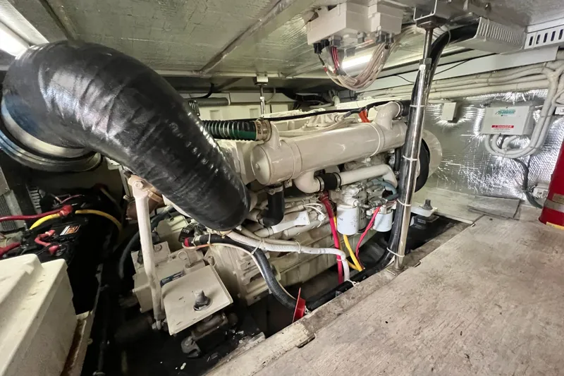 Slide: The Image of Engine room of a 2003 Carver 450 Voyager Pilothouse yacht, showcasing mechanical components. - 52