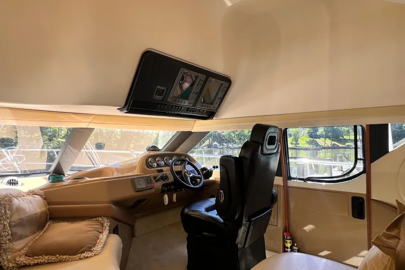 Slide: The Image of Interior of 2003 Carver 450 Voyager Pilothouse with helm and plush seating. - 19