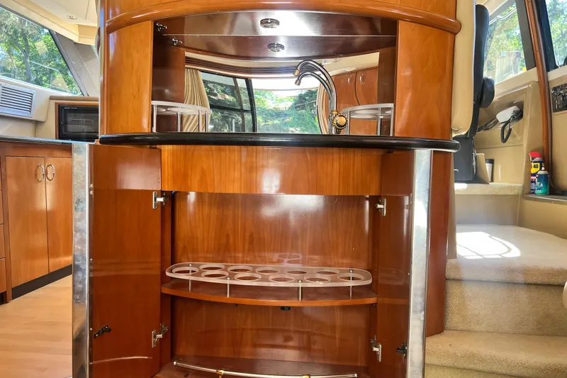 Slide: The Image of Interior of 2003 Carver 450 Voyager Pilothouse with wooden cabinetry and bar area. - 13