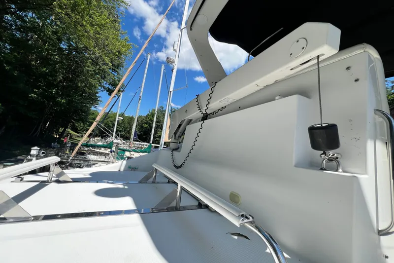 Slide: The Image of 2003 Carver 450 Voyager Pilothouse yacht deck with clear sky and marina view. - 47