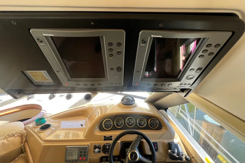 Slide: The Image of 2003 Carver 450 Voyager Pilothouse helm with Raymarine navigation displays and control instruments. - 15