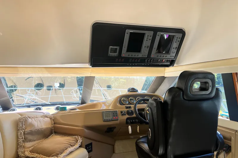 Slide: The Image of Interior of 2003 Carver 450 Voyager Pilothouse with helm and navigation equipment. - 16