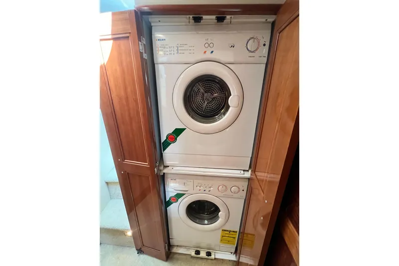 Slide: The Image of Stacked washer and dryer in 2003 Carver 450 Voyager Pilothouse laundry area. - 38